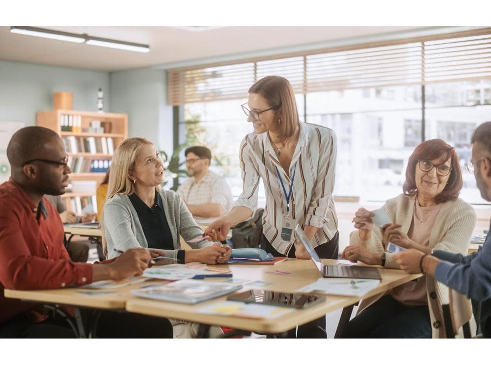 International school teachers meeting in a bright classroom